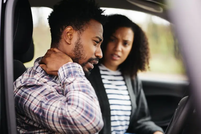 Charlotte car accident doctor examining patient for whiplash and soft tissue injuries after collision
